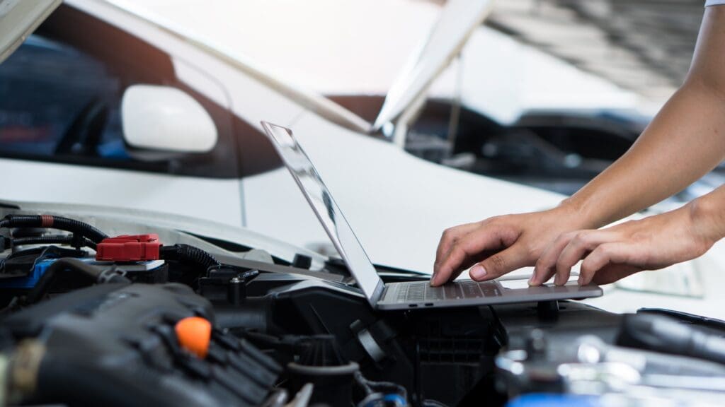 Mechanic using laptop to remap and tune a car engine at Star Garage Mansfield
