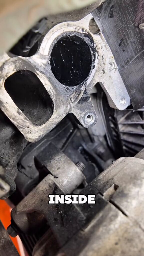 Carbon build-up in an engine intake port before walnut blasting at Star Garage Mansfield