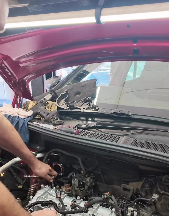 Technician working on top of a Peugeot 3008 1.5 BlueHDi engine during its cam chain upgrade at Star Garage Mansfield